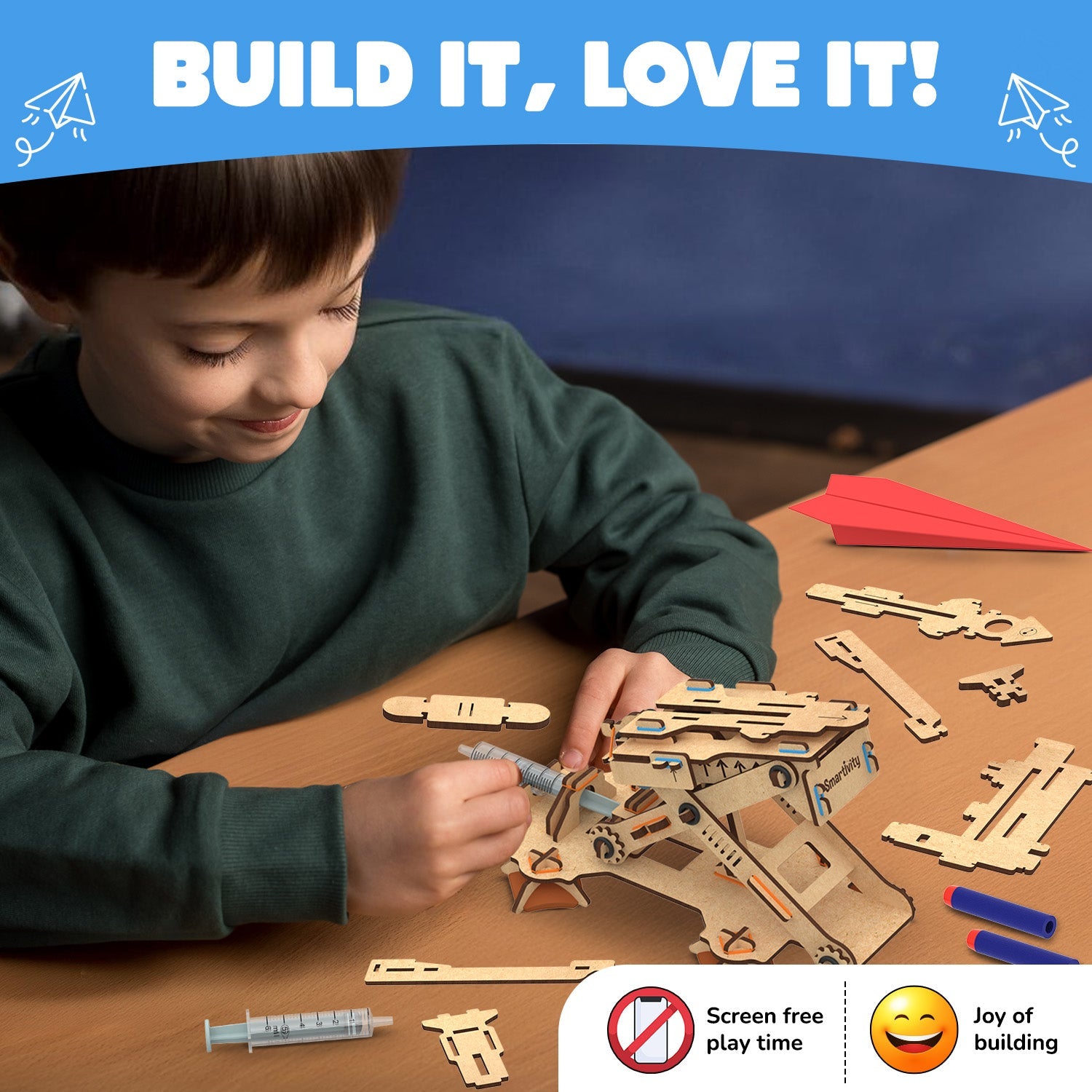 Child building a wooden puzzle toy with text 'Build It, Love It!' at the top.
