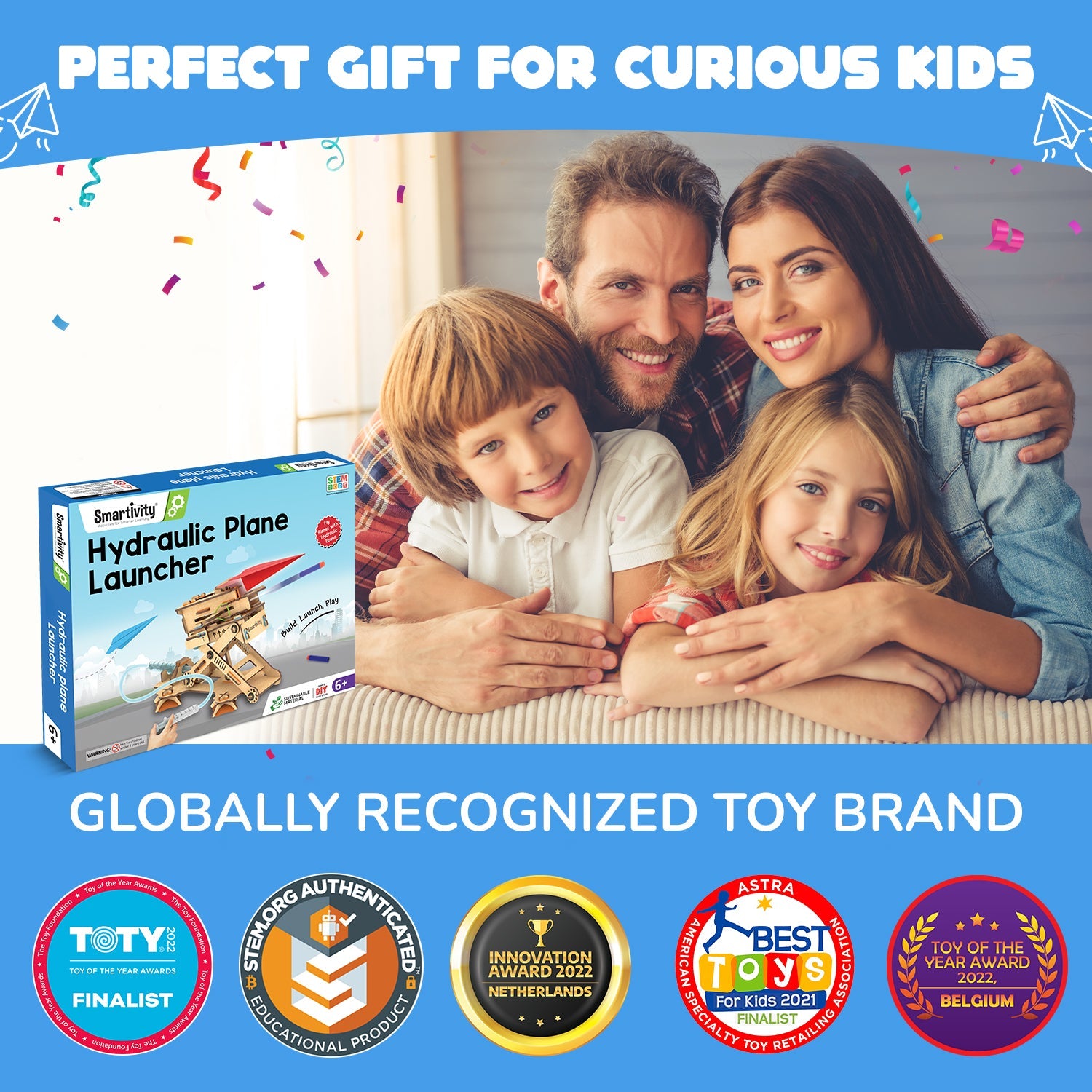 Family with children and a toy box labeled 'Hydraulic Plane Launcher' against a blue background with awards displayed.
